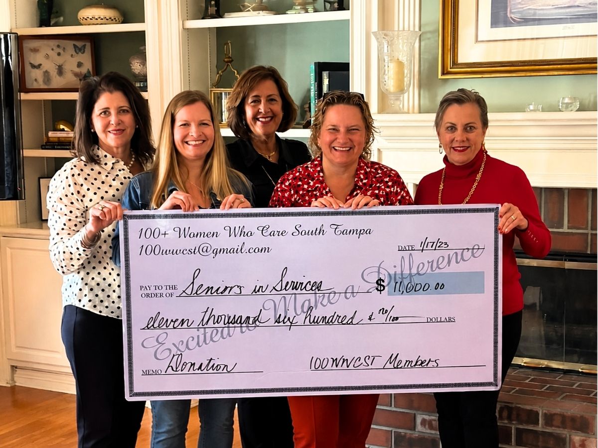 Representatives from 100+ Women Who Care South Tampa present an $11,600 donation to Seniors in Service to support the Classroom Grandparent tutoring and mentoring program.