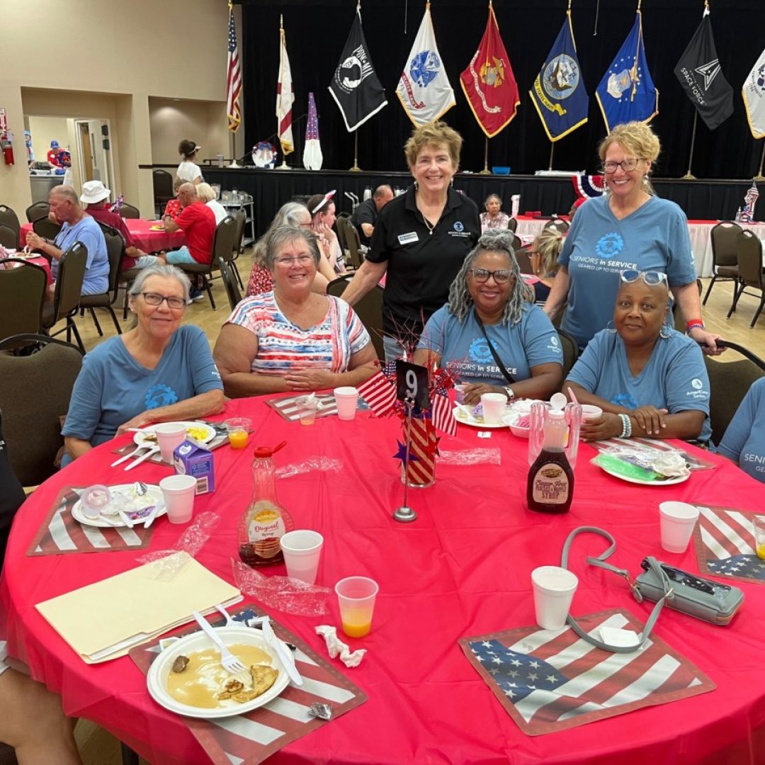 Seniors in Service staff and AmeriCorps Seniors RSVP South Shore volunteers smile at Fourth of July breakfast in Tampa Bay.