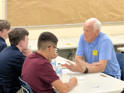 Seniors in Service Ambassador Vance mentors teenage boys at Ben Hill Middle School.