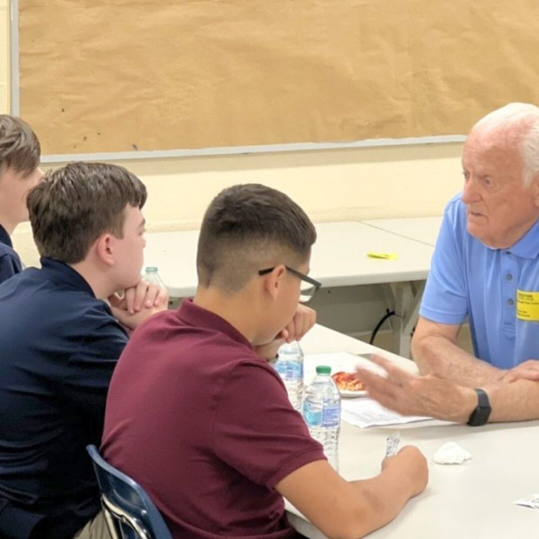 Seniors in Service Ambassador Vance mentors teenage boys at Ben Hill Middle School.