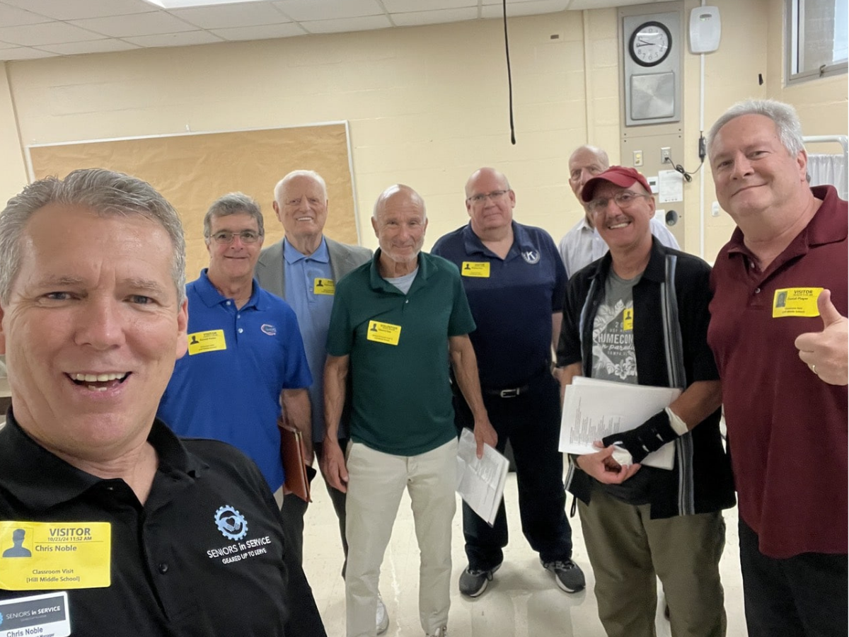 Volunteer mentors gather at Ben Hill Middle School before meeting with students through a youth mentoring program.
