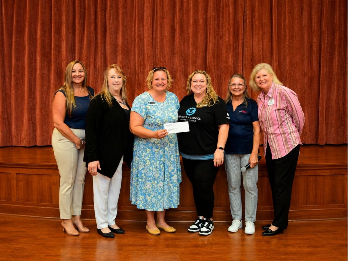Representatives from Better Living for Seniors and Seniors in Service celebrate support for senior companionship and connection programs.