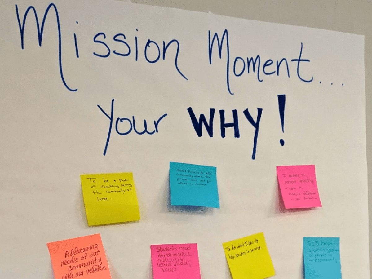 Sticky notes on a wall share what motivates Seniors in Service board members during a strategic planning retreat.