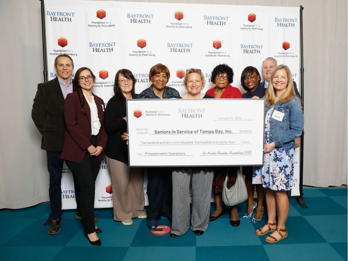 Classroom Grandparent volunteers, Seniors in Service staff, and representatives from Foundation for a Healthy St. Petersburg and Bayfront Health at a check presentation event.