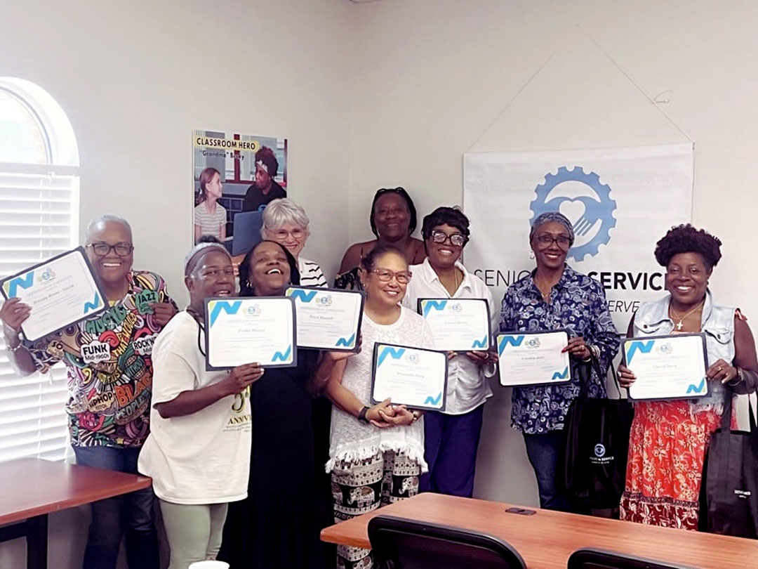New Classroom Grandparents volunteers pose with orientation certificates before beginning service in elementary schools across Tampa Bay.