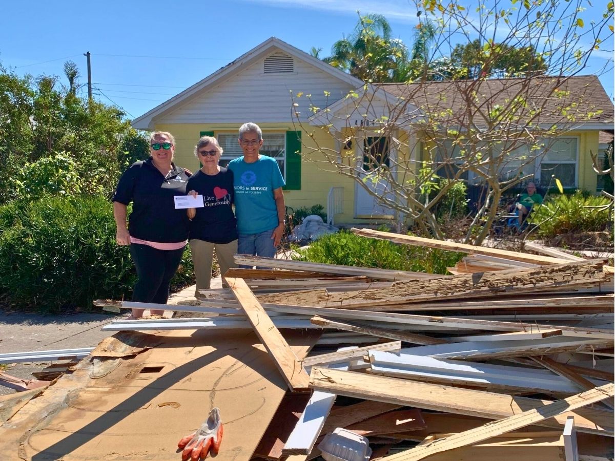 Volunteer provides support and resources to a senior affected by Hurricanes Helene and Milton in Tampa Bay.
