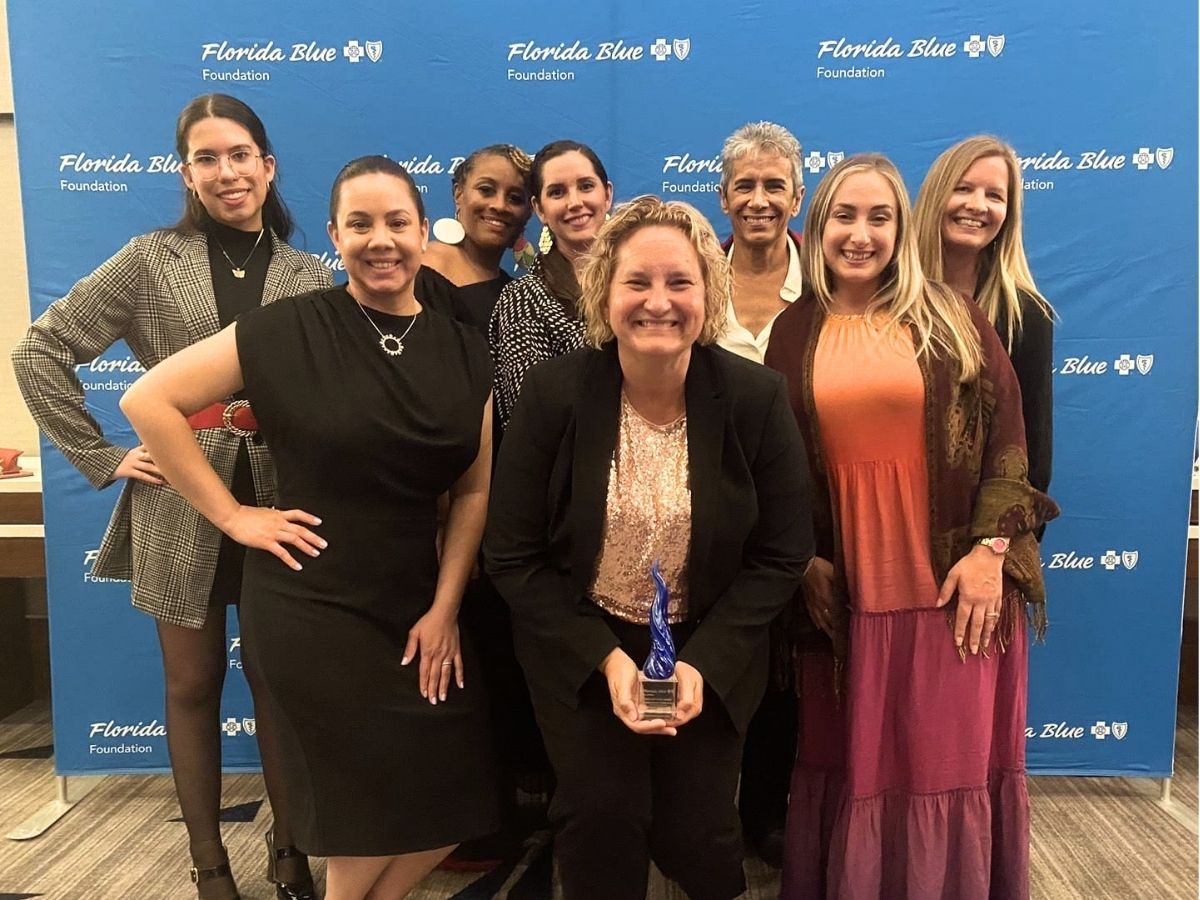 Seniors in Service team members show their Sapphire Award at a Florida Blue Foundation recognition event in 2023.