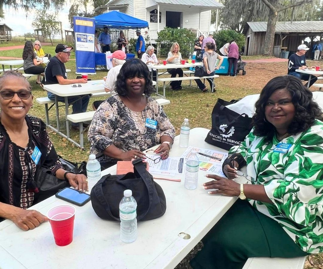 Volunteers and community partners gather outdoors during a Geared Up Gathering volunteer appreciation event in Pasco County.