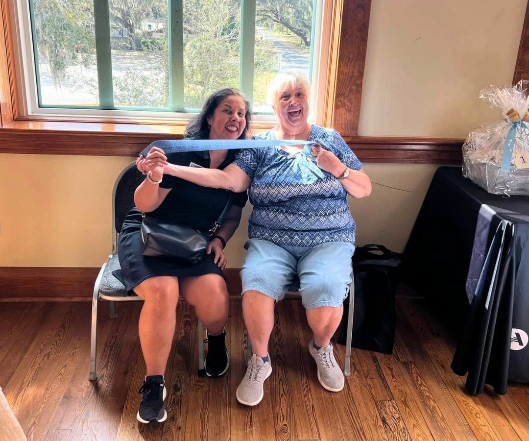 Two volunteers smile and laugh together during a Geared Up Gathering volunteer appreciation event.