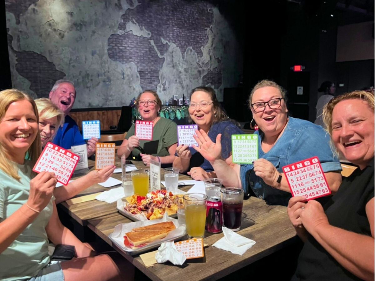 Supporters hold bingo cards during a Golden Girls-themed fundraiser benefiting veterans through Operation: Veteran Connect in St. Petersburg.