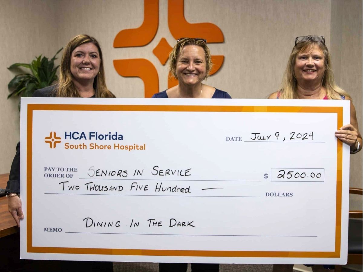 Representatives from HCA Florida South Shore Hospital present a sponsorship donation to Seniors in Service for the Dining in the Dark fundraiser supporting adults with blindness and low vision.