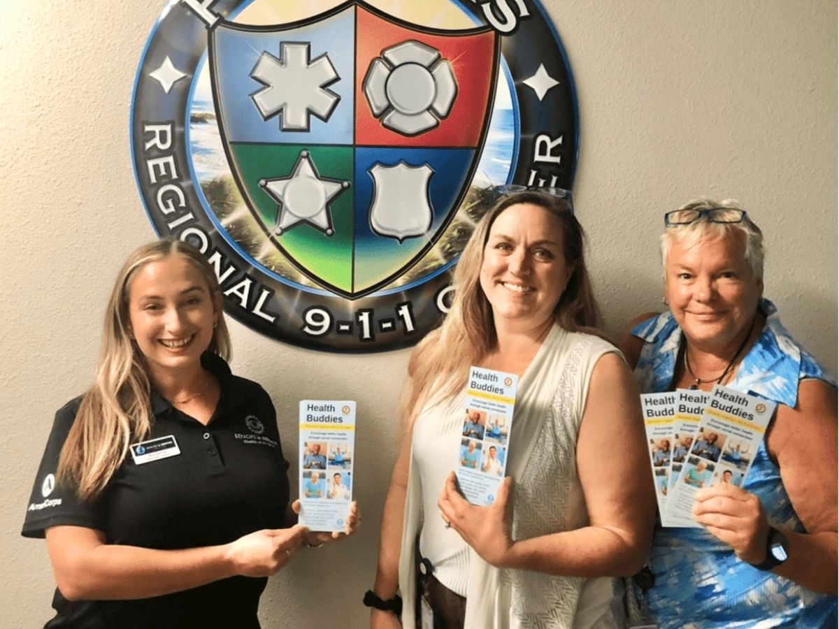 Representatives from Seniors in Service's Health Buddies program and Pinellas County EMS promote their partnership to connect isolated older adults with volunteer companionship and wellness support.