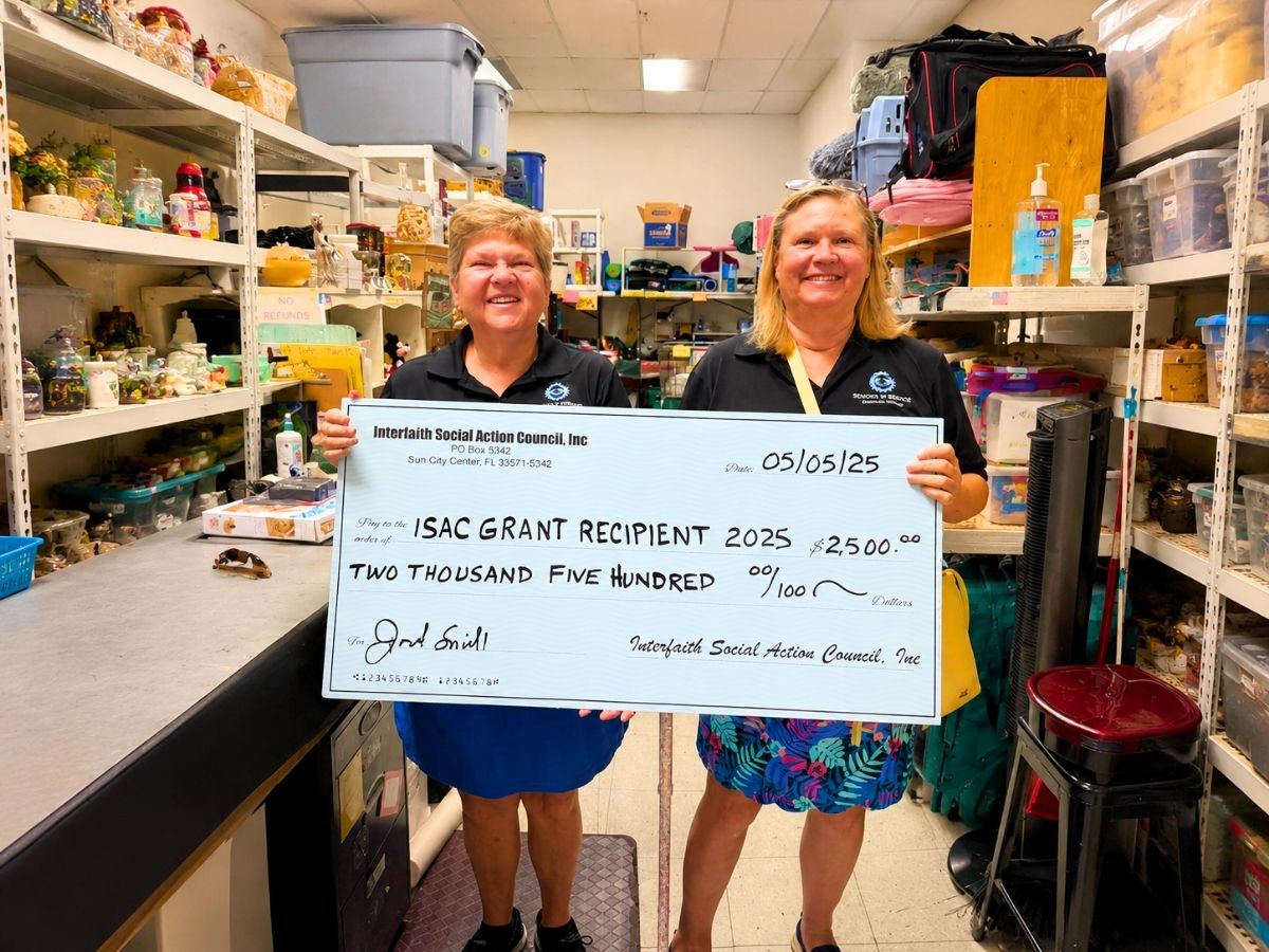Seniors in Service representatives hold a grant award from the Interfaith Social Action Council supporting Low Vision Support Group services and assistive technology for seniors.