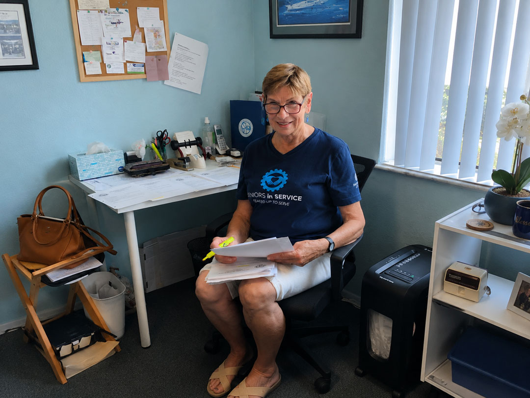 Jan, an RSVP volunteer with Seniors in Service, reviews paperwork while volunteering at the VA Outpatient Clinic in New Port Richey.