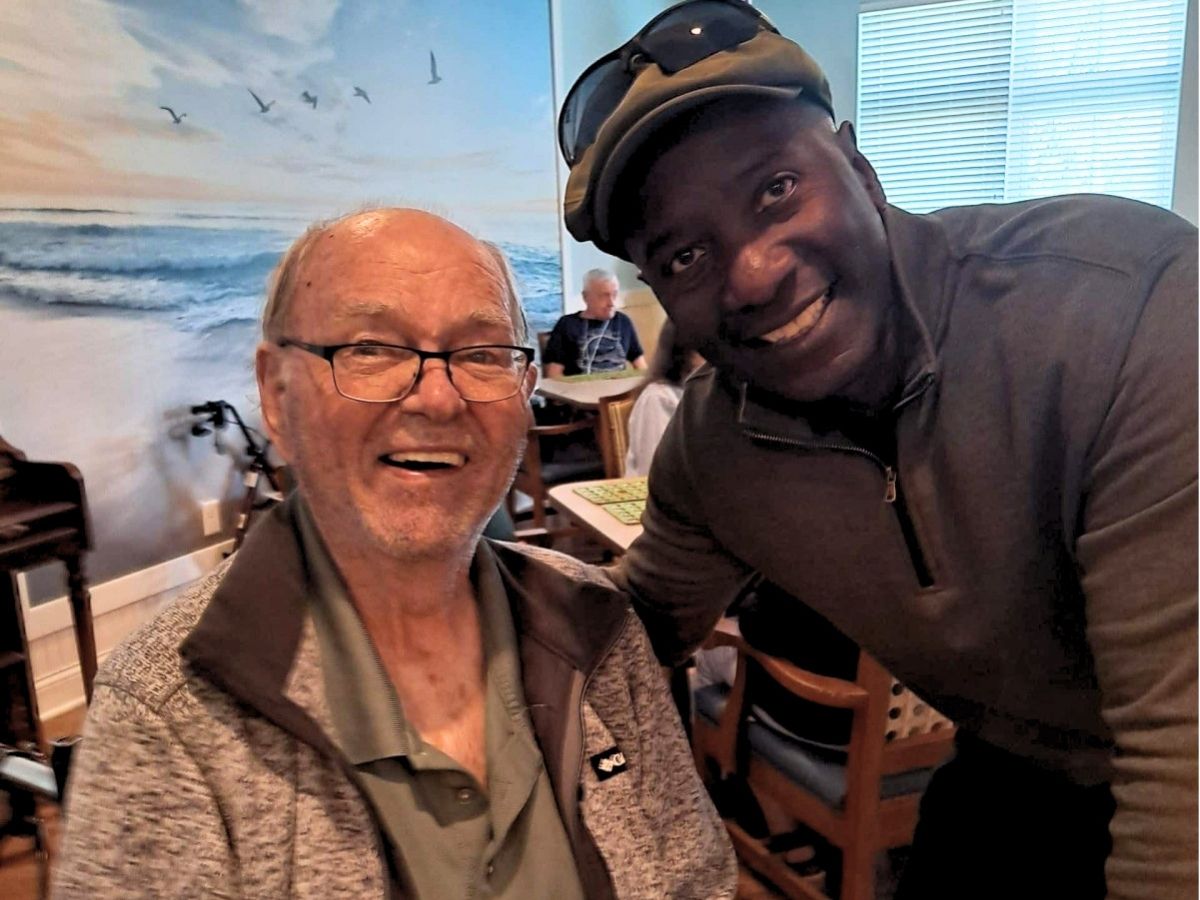 Senior Companion volunteer Ken visits with resident Jack at Keystone Place, building friendship and reducing social isolation.