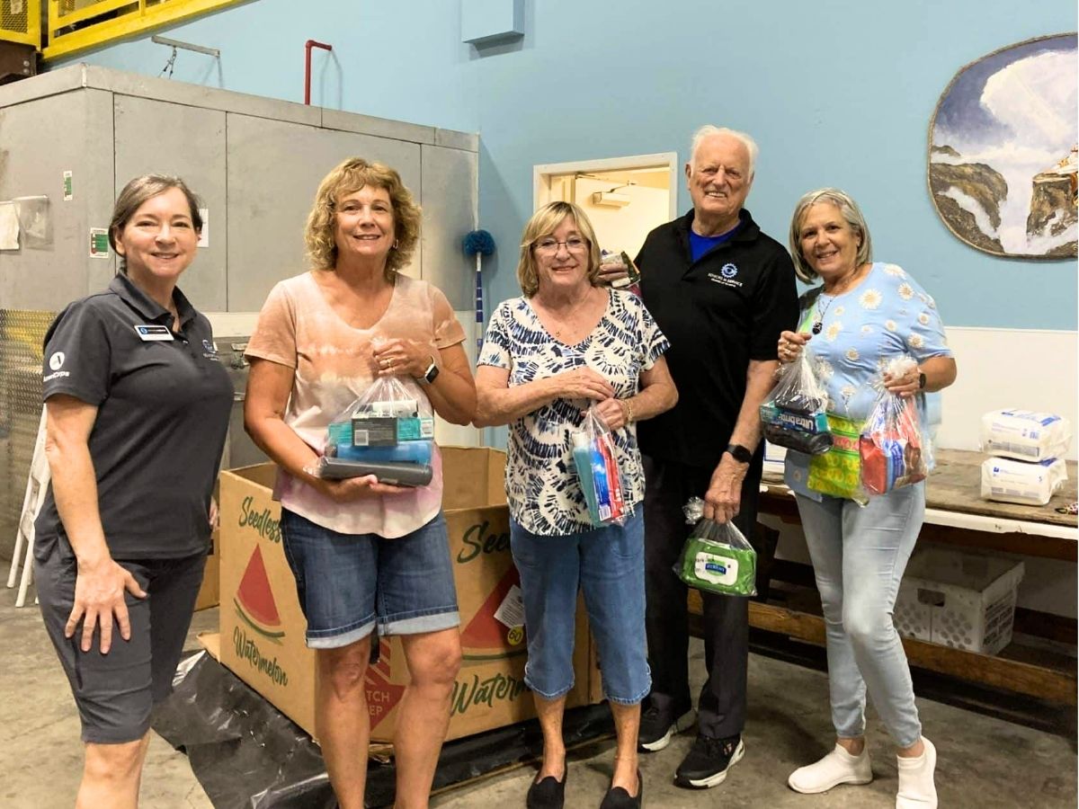 Seniors in Service volunteers display Kindness Kits filled with hygiene supplies and pet food for homebound seniors in Pasco County.