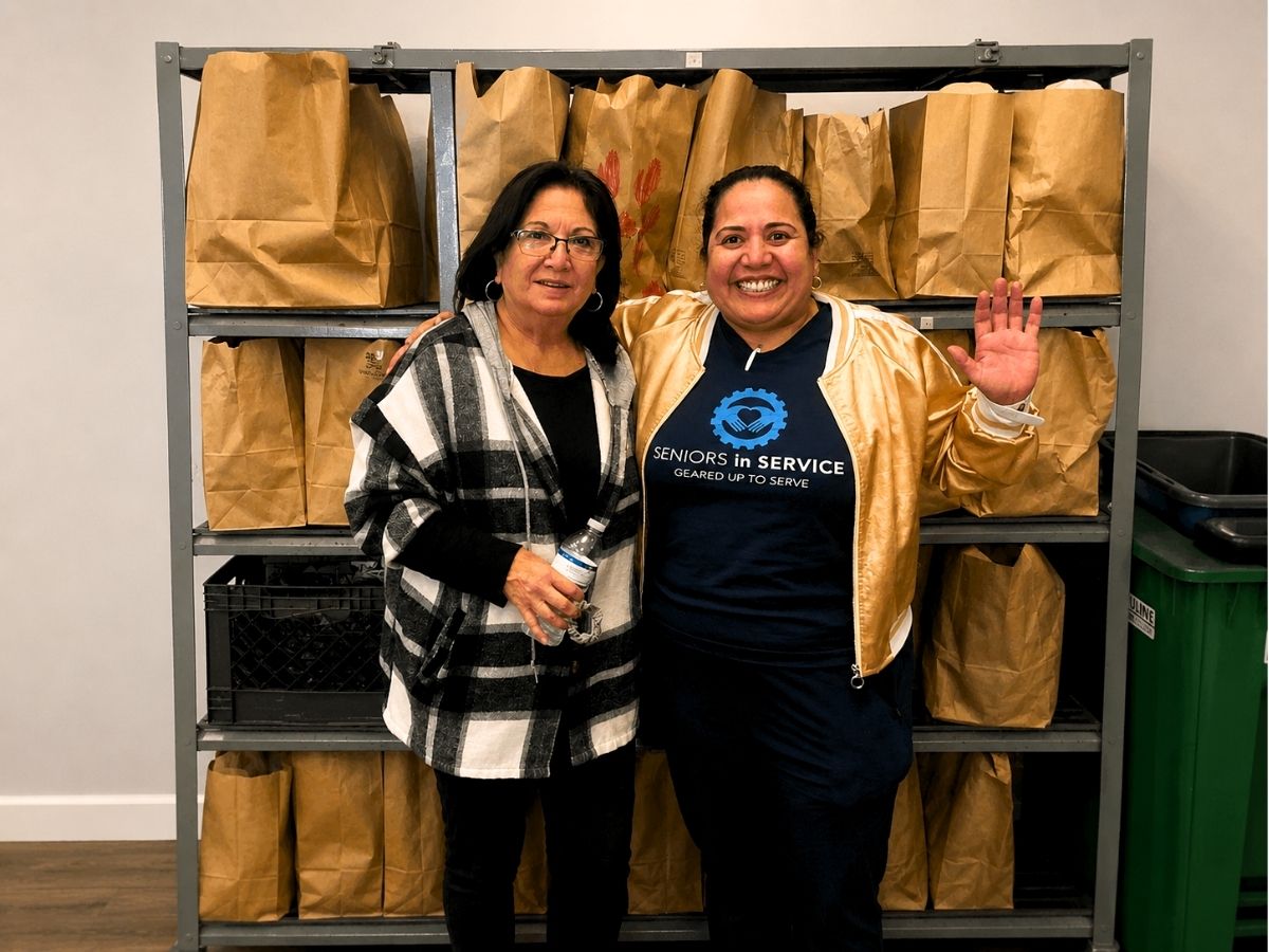 RSVP volunteer Laura Oddo poses with a Seniors in Service team member during a community volunteer event in Tampa Bay.