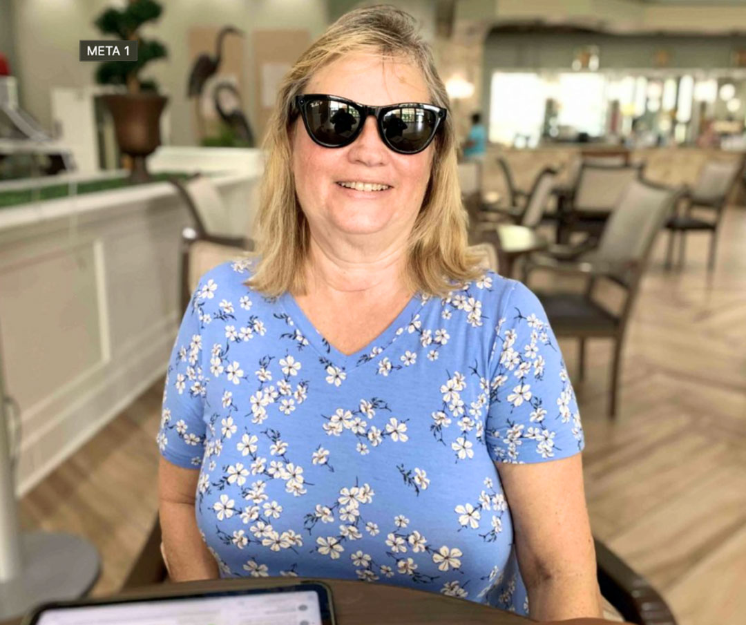 Senior participating in the Low Vision Support Group wears Meta Glasses during assistive technology training focused on independence and daily living support.