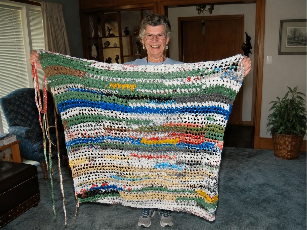 Seniors in Service volunteer displays a sleeping mat crocheted from recycled plastic bags during the Martin Luther King Jr. Day of Service.