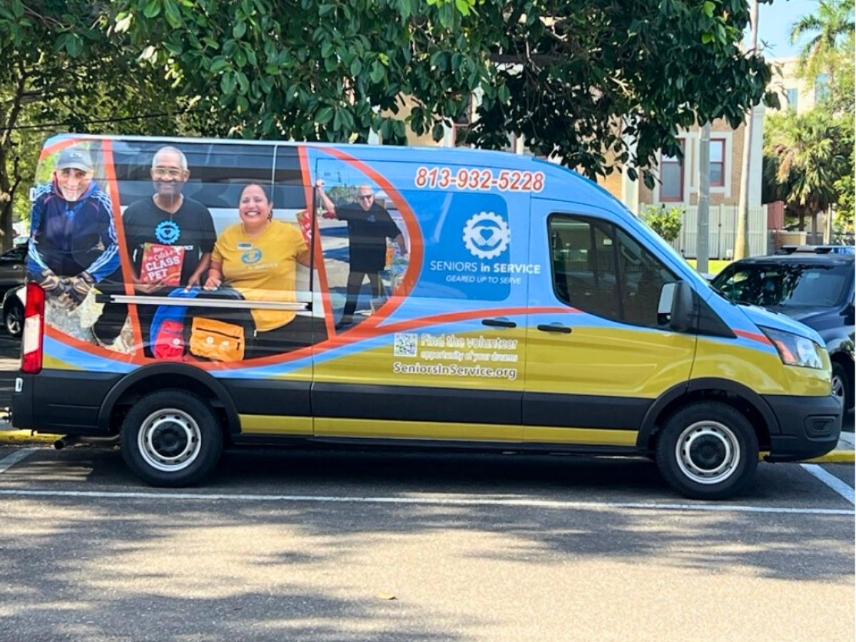 Seniors in Service mobile outreach van parked in the community, supporting volunteer recruitment, literacy programs, and senior services across Tampa Bay.