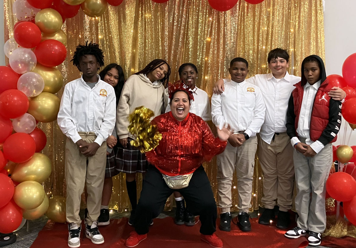 Nat the Elf poses with students during a Seniors in Service volunteer appreciation and community celebration event.