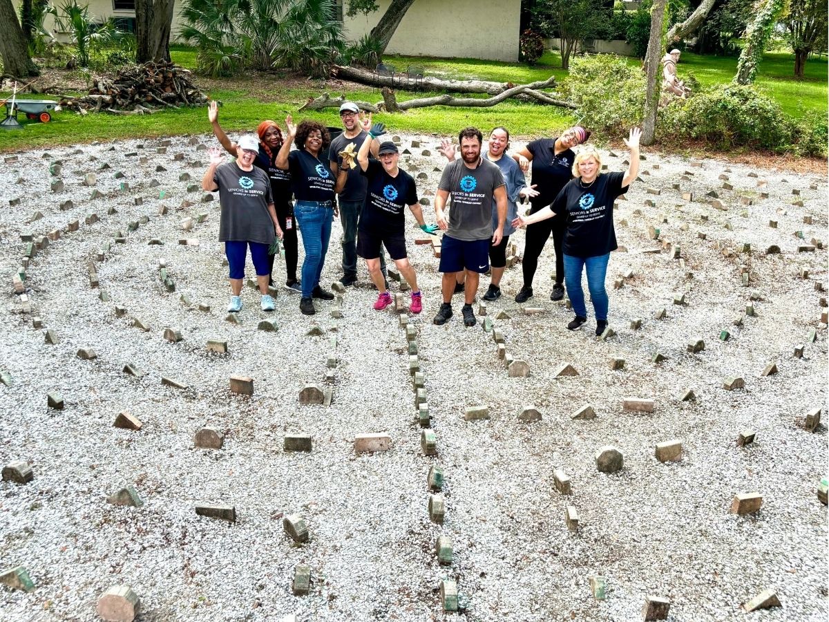 Operation: Veteran Connect volunteers gather at the St. Francis Labyrinth after completing a 9/11 Day of Service project at The Franciscan Center.