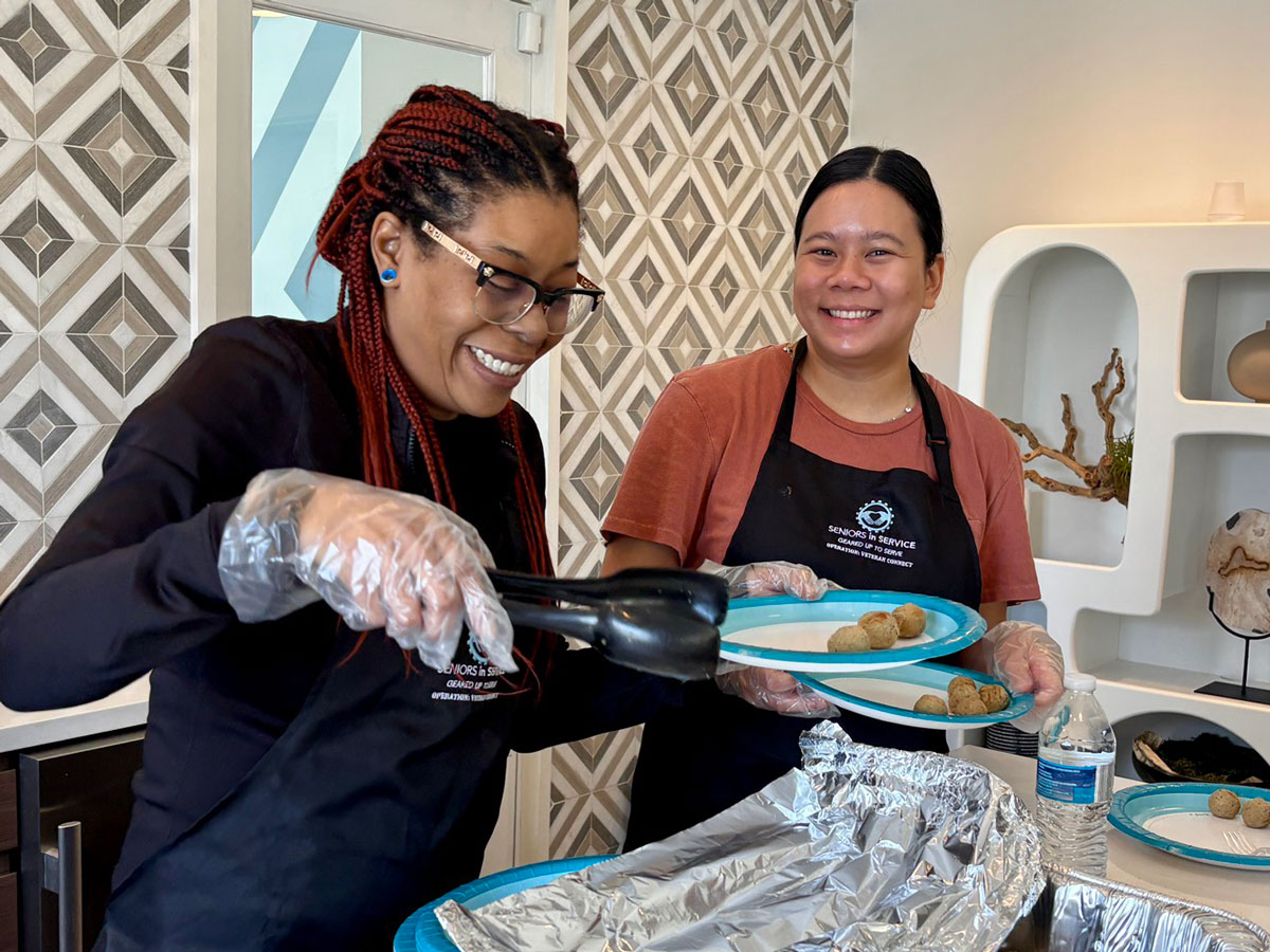 Operation: Veteran Connect volunteers prepare and serve food during a veteran community gathering in Tampa Bay.