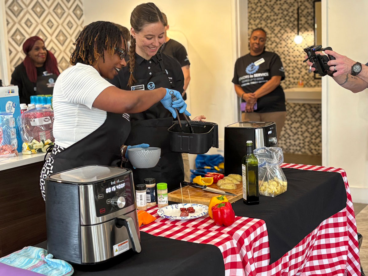 Veterans participate in a hands-on cooking demonstration using air fryers during an Operation: Veteran Connect wellness event in Tampa Bay.