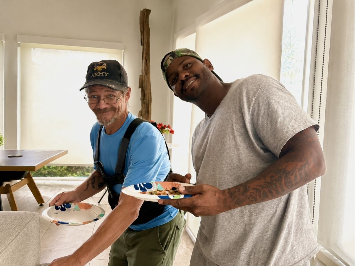 Two veterans share a meal and conversation during an Operation: Veteran Connect community gathering designed to reduce isolation and build connections.