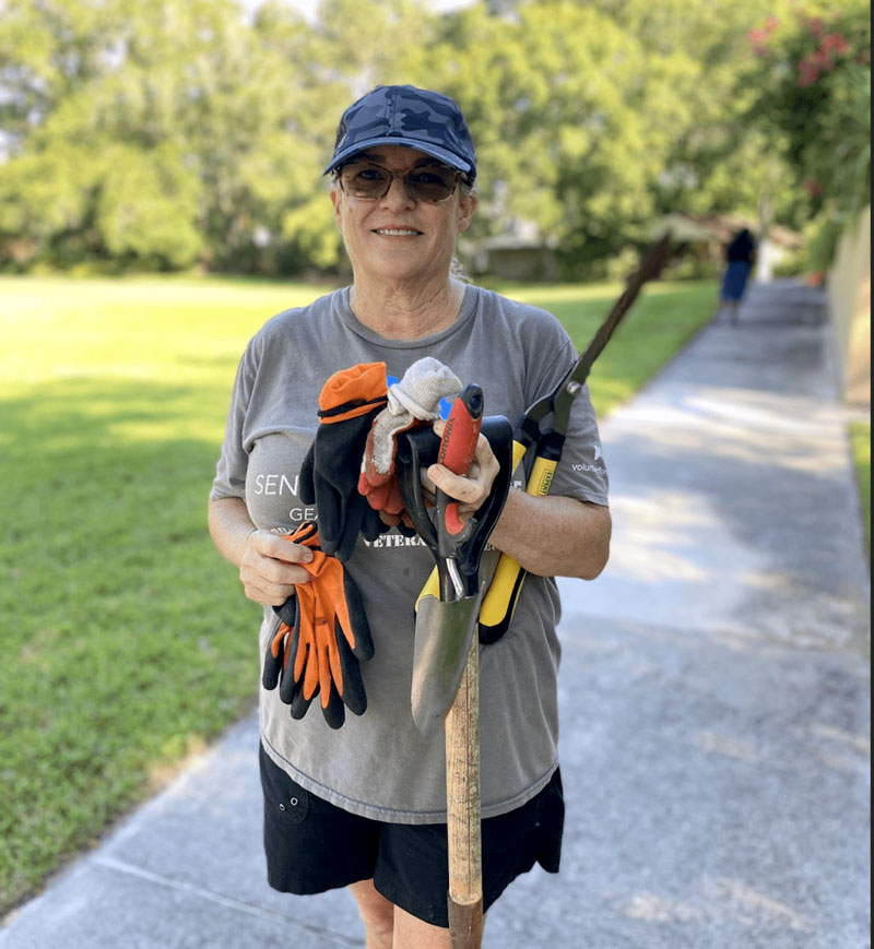 Operation: Veteran Connect volunteer prepares for the 9/11 Day of Remembrance Service Project with gardening tools at The Franciscan Center in Tampa.