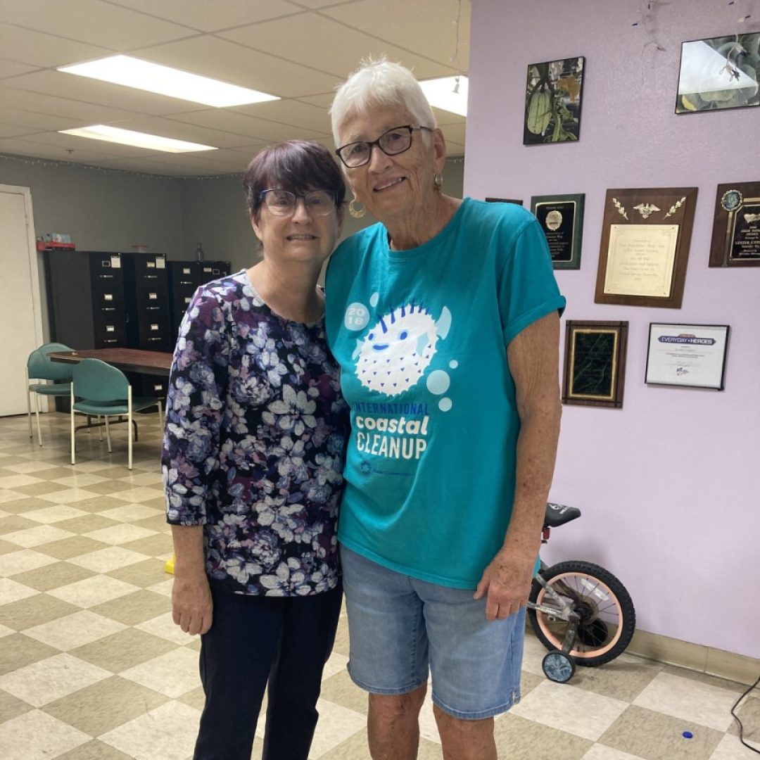 Senior volunteer and older adult sharing time together during a companion visit in Pasco County.