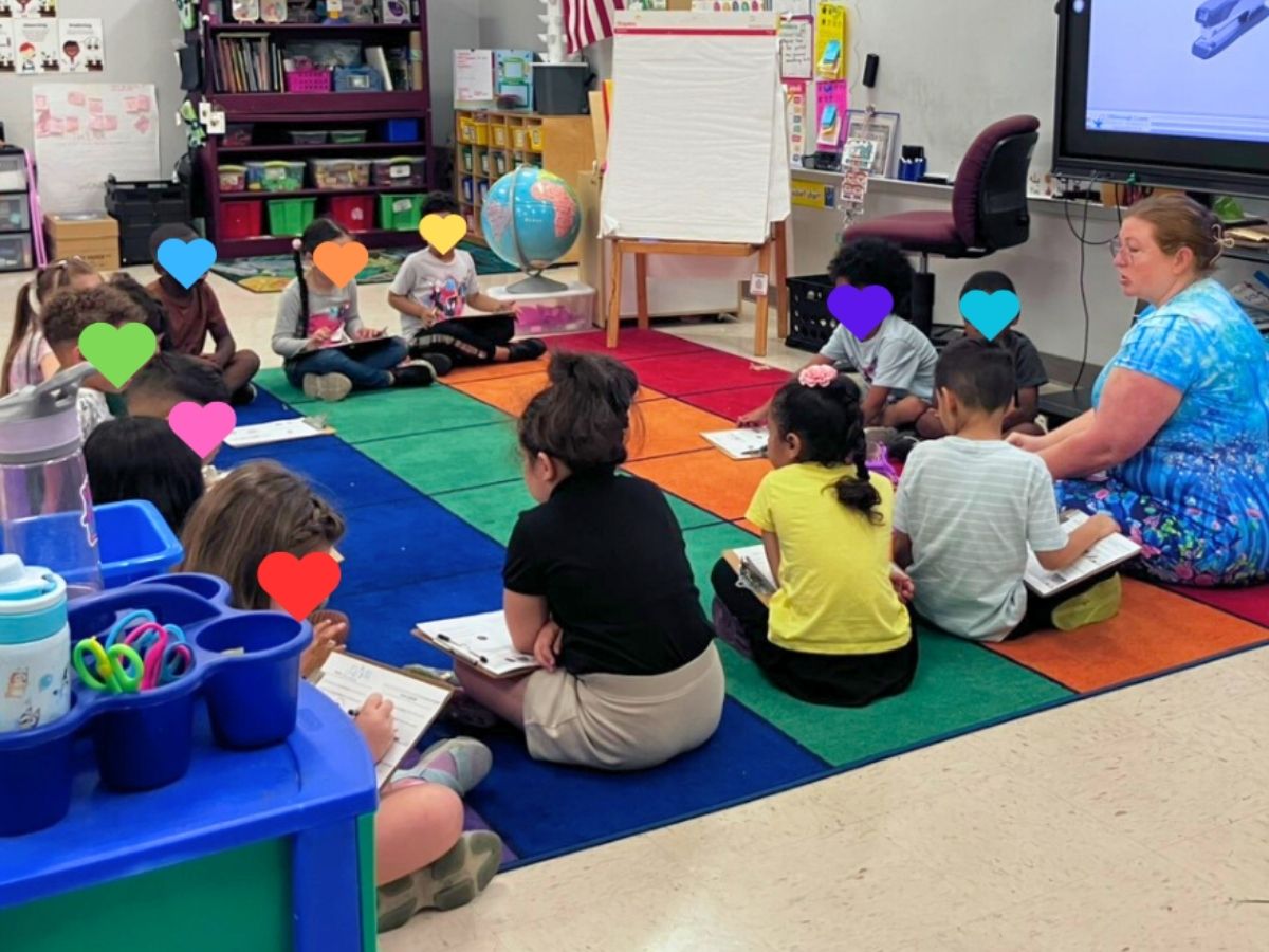 Elementary students participate in a Readers in Motion literacy activity with their teacher during classroom reading time.