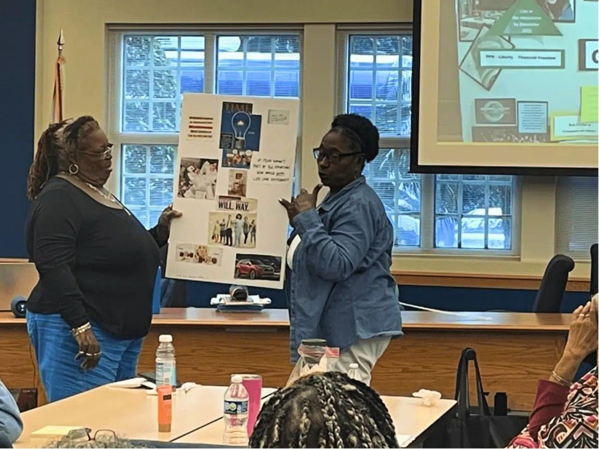Readers in Motion volunteers present a vision board during an in-service training focused on setting goals and strengthening volunteer leadership.