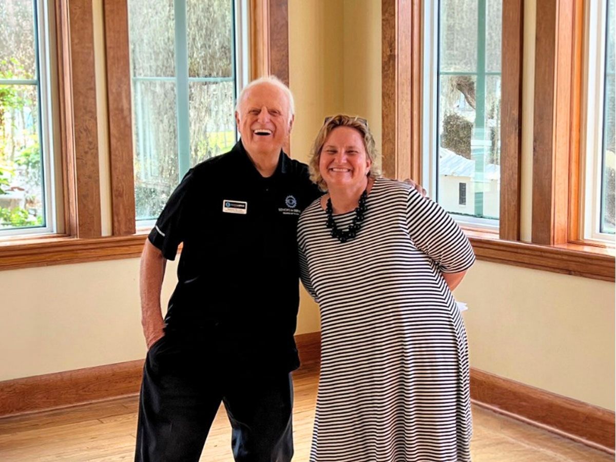 Seniors in Service CEO Corner Robin Ingles smiling with Seniors in Service Ambassador Raymond at community event.