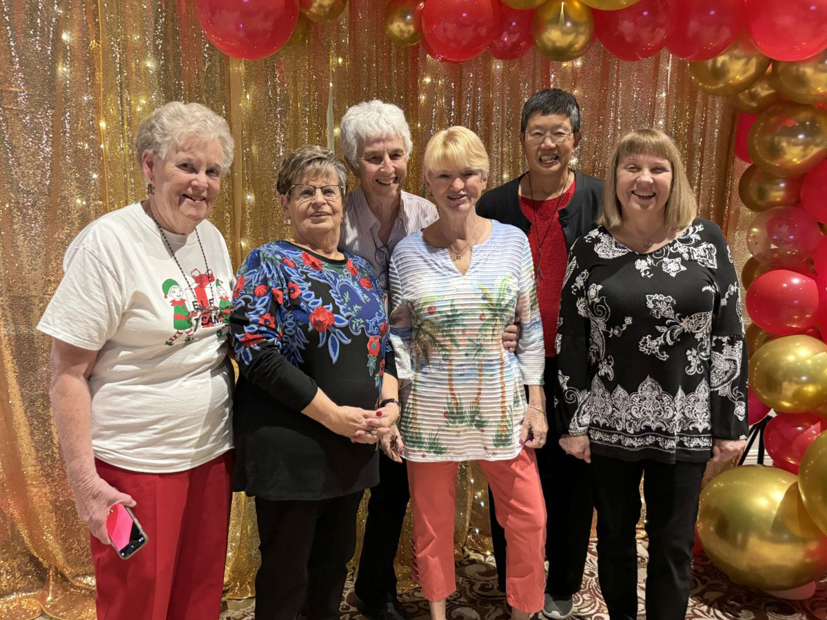 Group of Seniors in Service volunteers posing at the Ruby Celebration volunteer appreciation luncheon honoring years of community service.