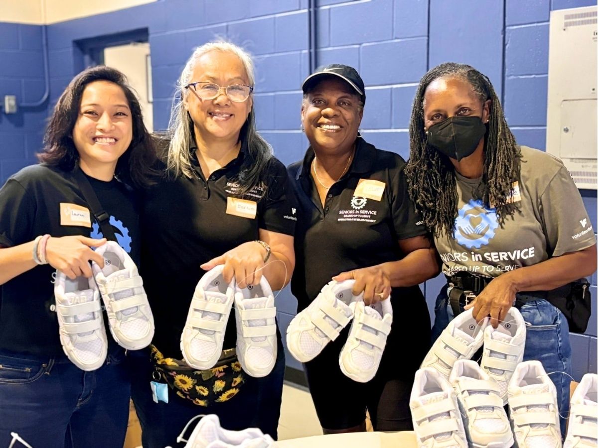 Volunteers display new shoes provided to Tampa Bay seniors during a Samaritan's Feet 9/11 Day of Service event.
