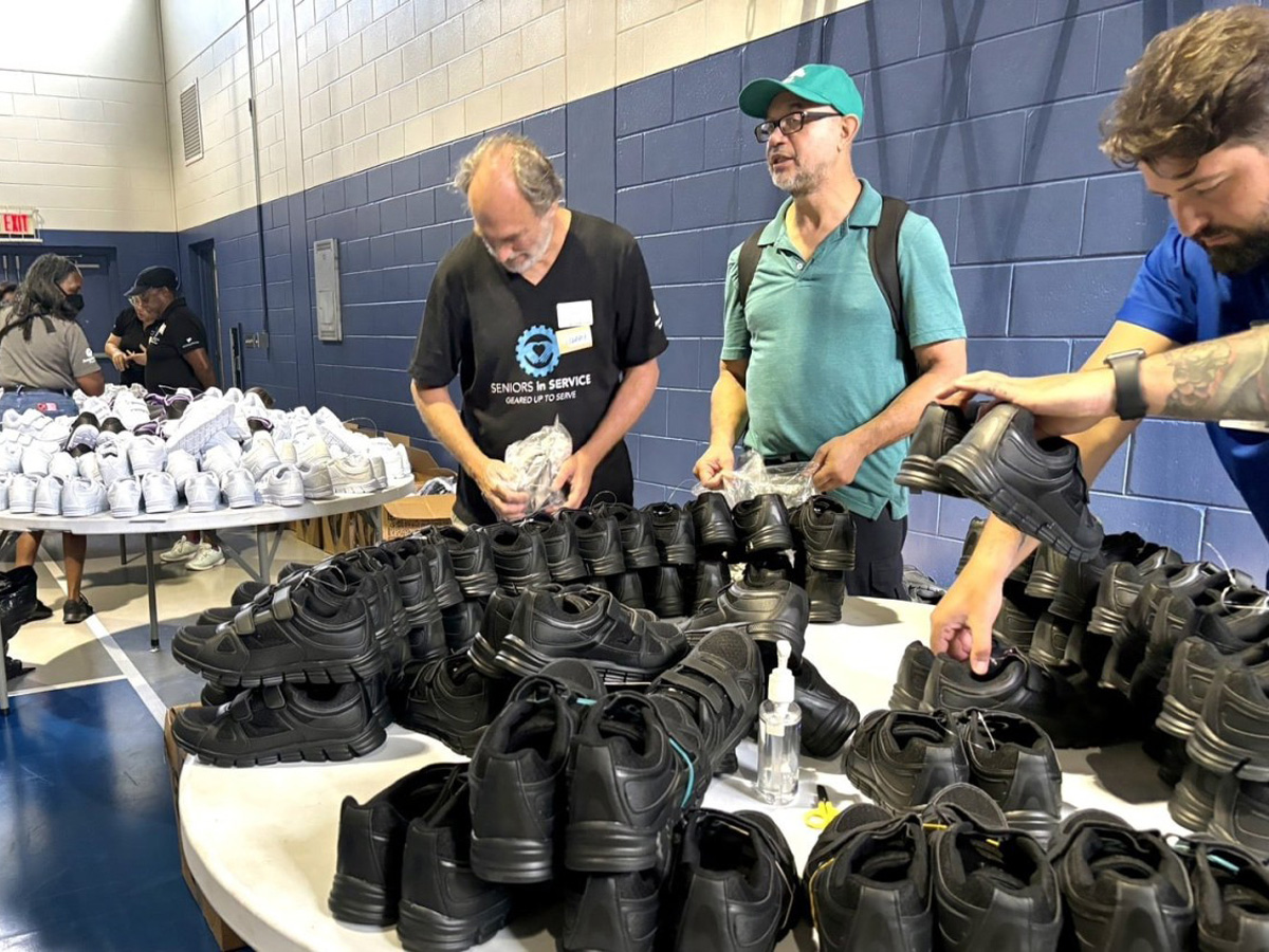 Volunteers organize and prepare new shoes for seniors during a Samaritan's Feet community shoe giveaway event in Tampa Bay.