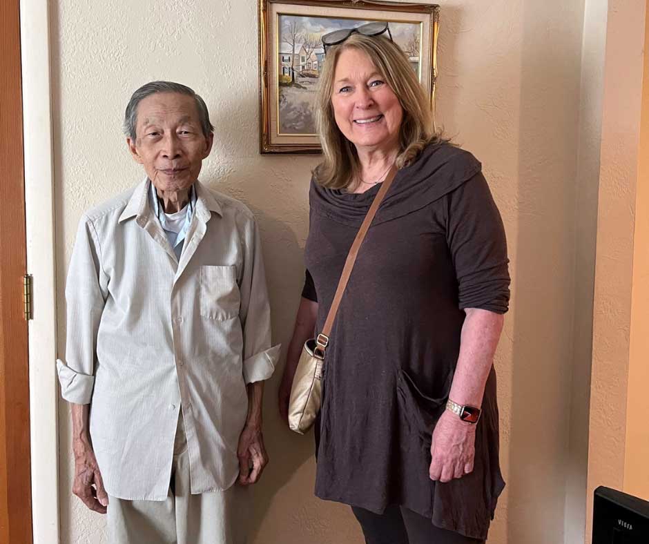 A Seniors in Service Senior Companion volunteer visits with an older adult during a home companionship visit.