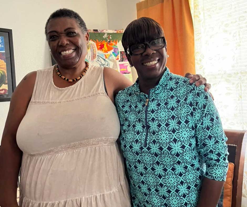 A Seniors in Service volunteer and Senior Companion client share a smile during a home visit in Pinellas County.