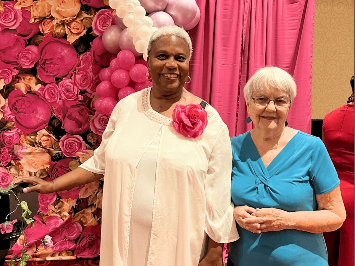 Senior Companion volunteer Doris and participant Angela Parker smiling together at a community event celebrating their friendship.