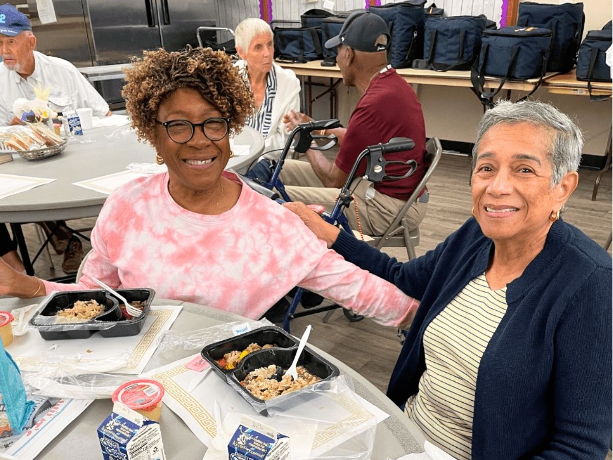 Seniors gather for a community meal and social event hosted by the Senior Disaster Support Program, building friendships, support networks, and resilience among older adults in Pinellas County.