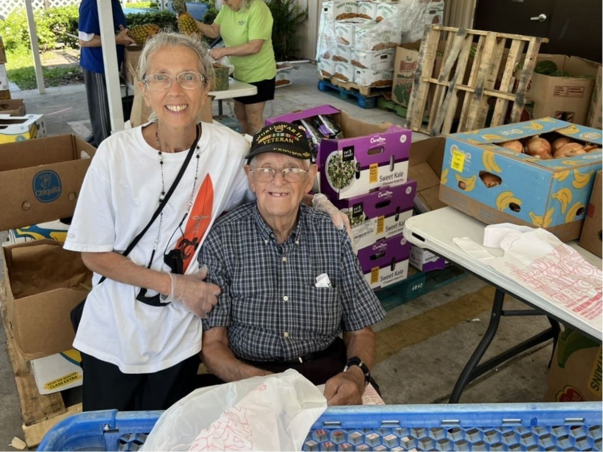 Senior volunteers Maurice and Cathleen help distribute fresh food at Beth-El Farmworkers Food Pantry in Wimauma, Florida.