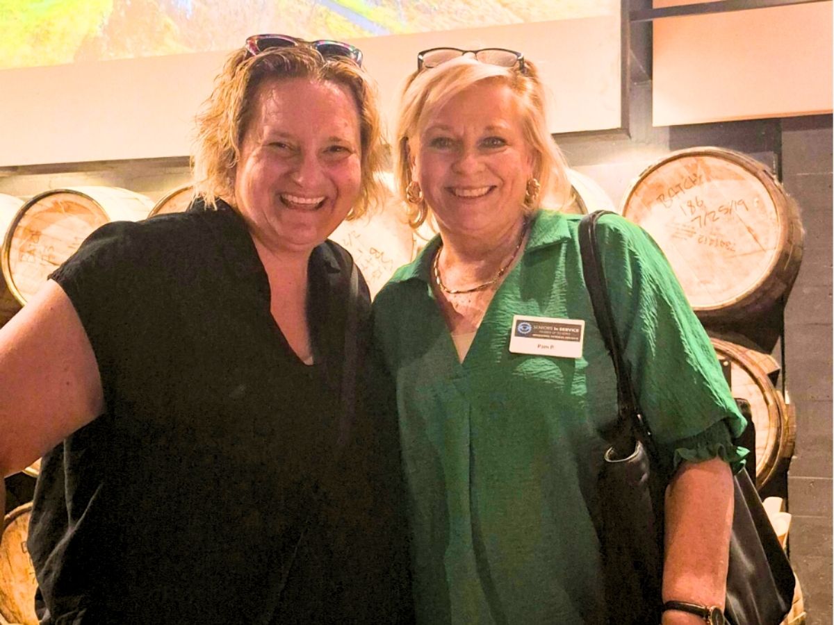 Seniors in Service CEO Robin Ingles smiling with staff member Pam Plager in Tampa Bay.