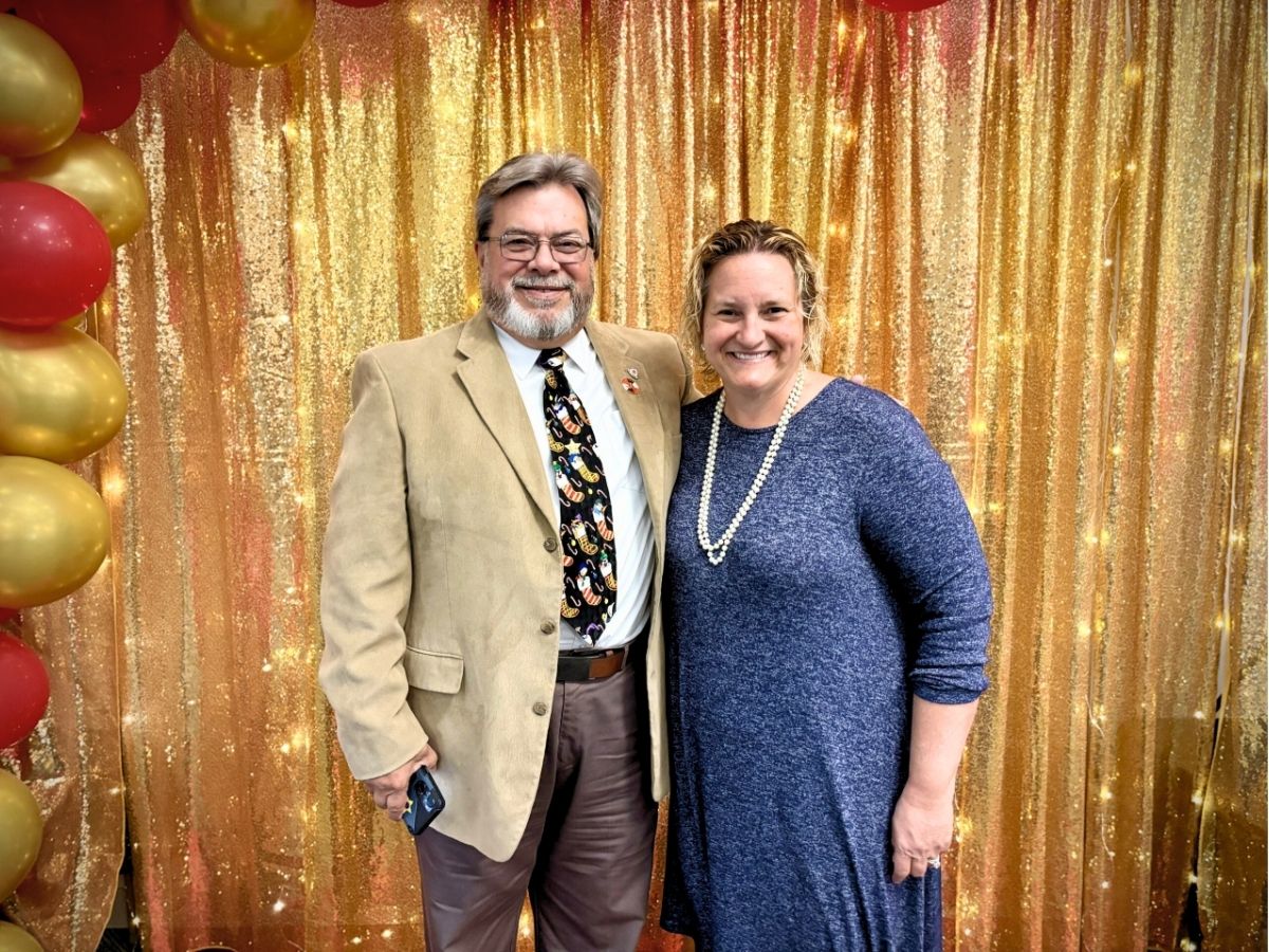 Seniors in Service CEO Robin Ingles smiling with a volunteer at a Tampa Bay volunteer appreciation luncheon.