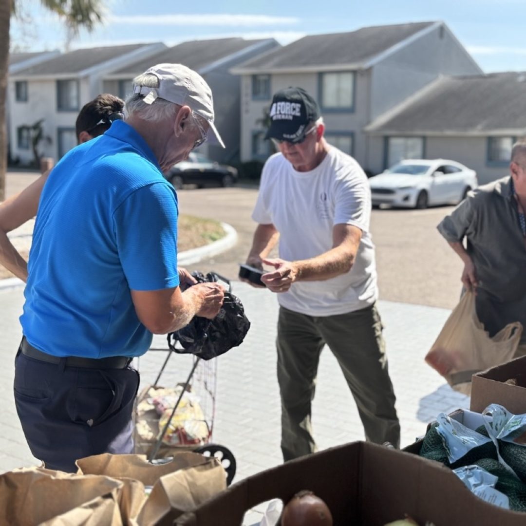 Tampa Bay veterans collect fresh produce from a Seniors in Service mobile food pantry event.