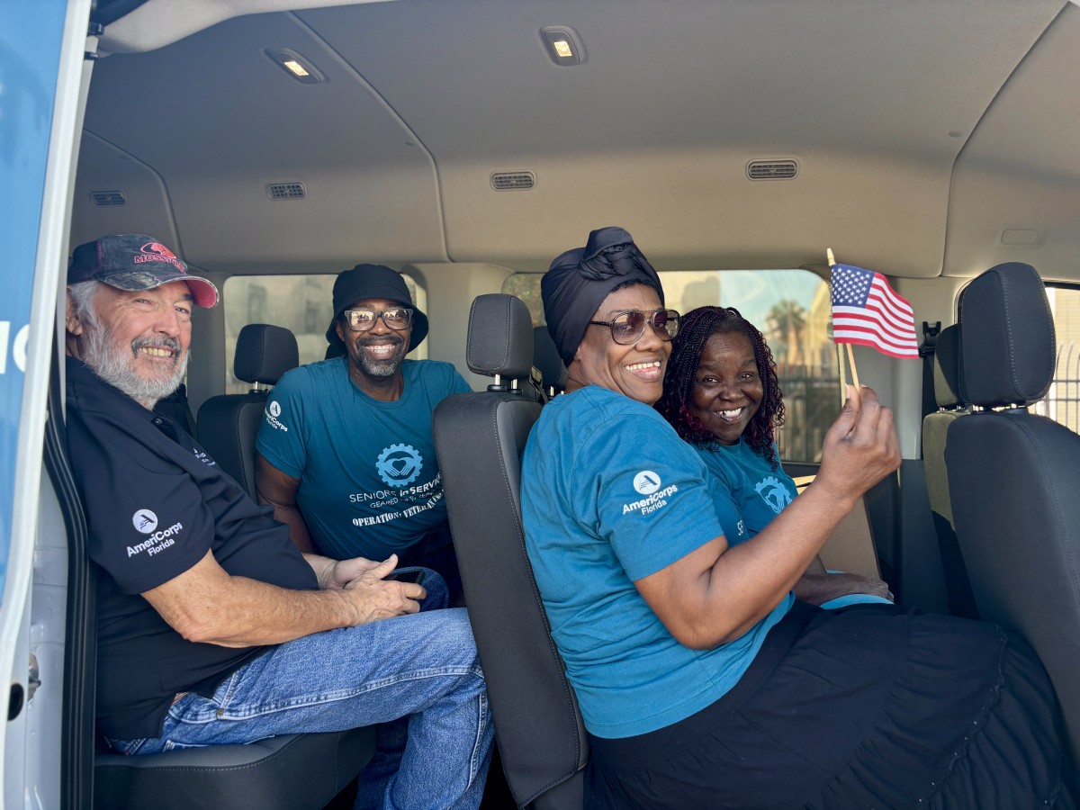Group of Operation: Veteran Connect volunteers in Seniors in Service van traveling to a Veterans Day parade.