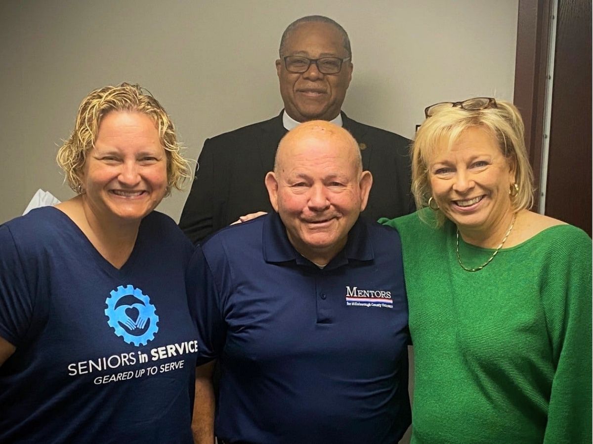 Seniors in Service CEO Robin Ingles with staff member Pam Plager and community members at a courthouse supporting veterans.