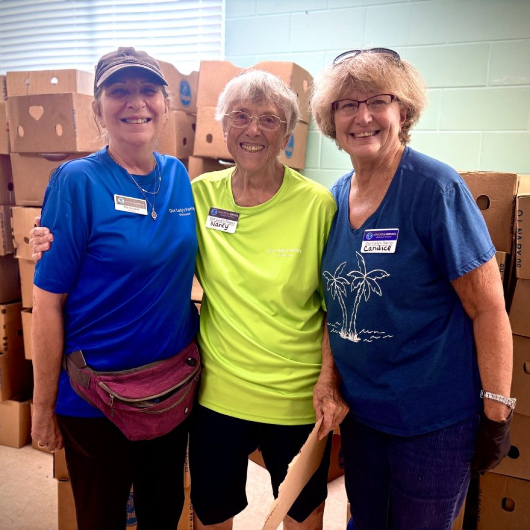 Seniors in Service volunteers gather for a photo at a Tampa Bay food pantry.