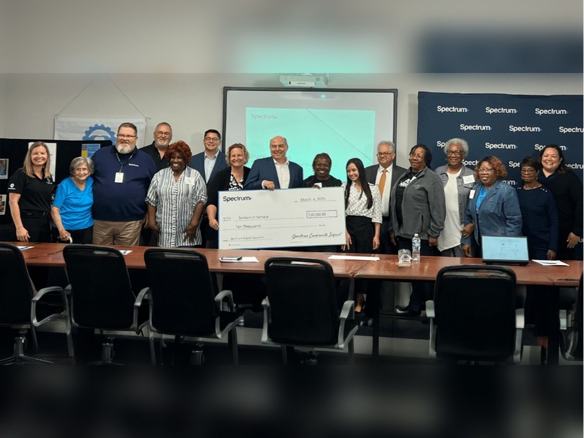 Spectrum representatives, community leaders, and Seniors in Service staff celebrate a Digital Education Grant supporting technology training and digital literacy programs for older adults.
