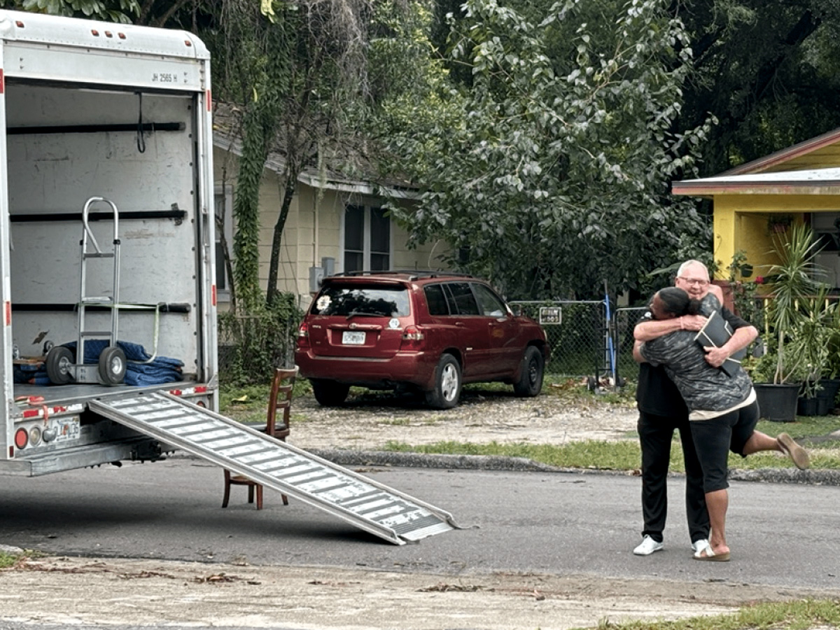 A Tampa Bay resident embraces a volunteer after receiving assistance during hurricane recovery efforts.